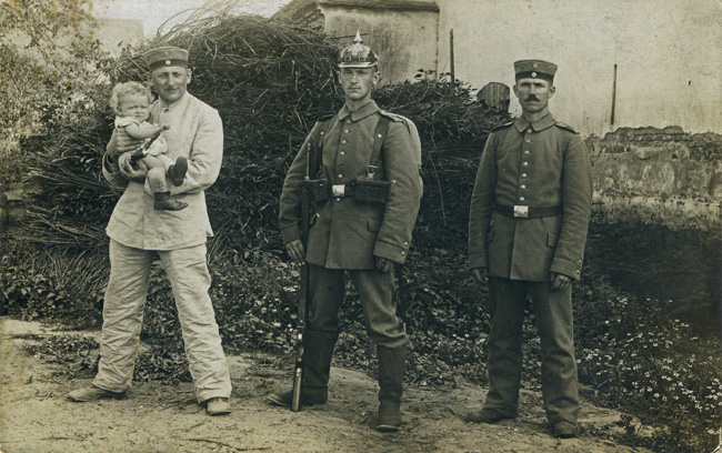 Three members of the 3. Kompagnie / I. Ersatz-Bataillon / LIR 104 (and a young friend) in August 1914, presumably pictured in Breslau.