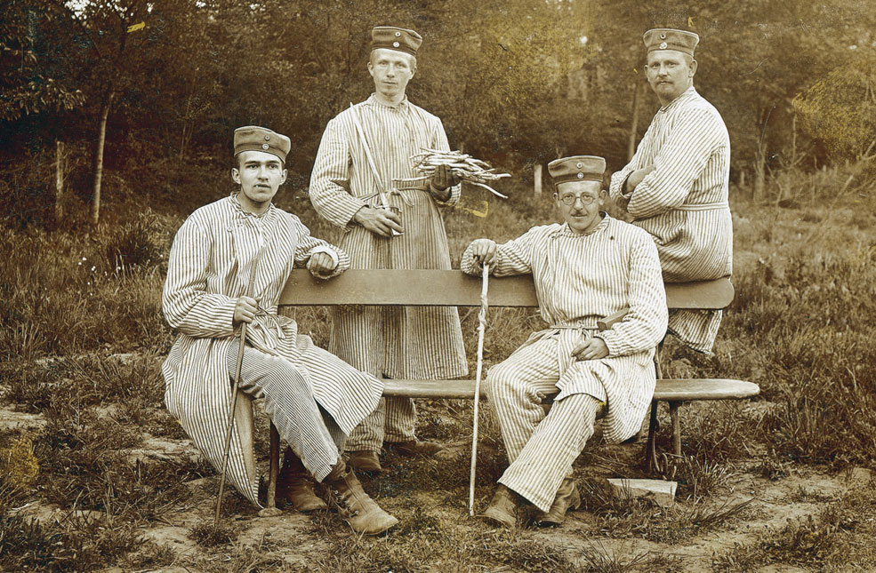 Hans Berthelen of SR 108 and comrades in the chateau grounds, all wearing striped hospital pyjamas